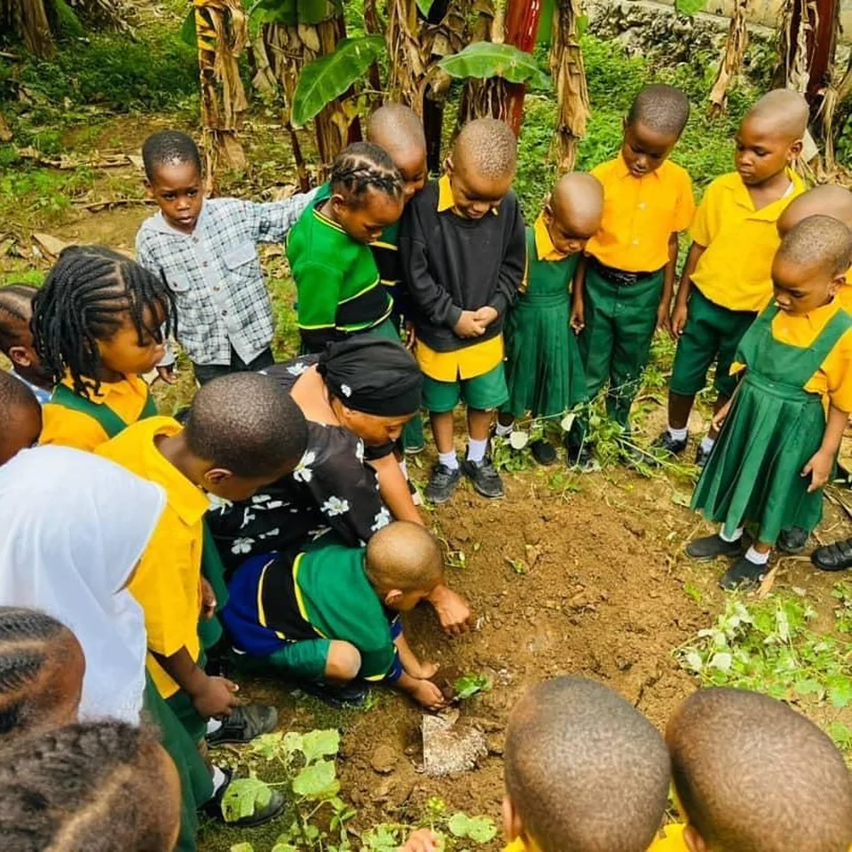 Early-years pupils learning together in the school garden
